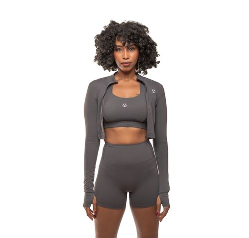 Free Model in grey sportswear showcasing athletic fashion, front view. Stock Photo