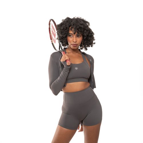 Free Confident woman in sportswear holding a tennis racket on a white background. Stock Photo