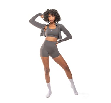 Sporty look with a model in a gray two-piece activewear set posing confidently indoors.