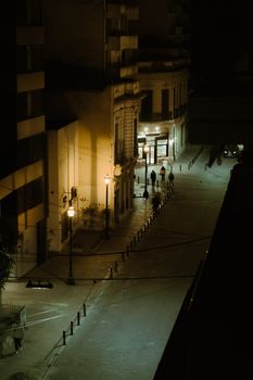A moody, quiet night street scene captured in Rosario, Argentina. Atmospheric and cinematic.