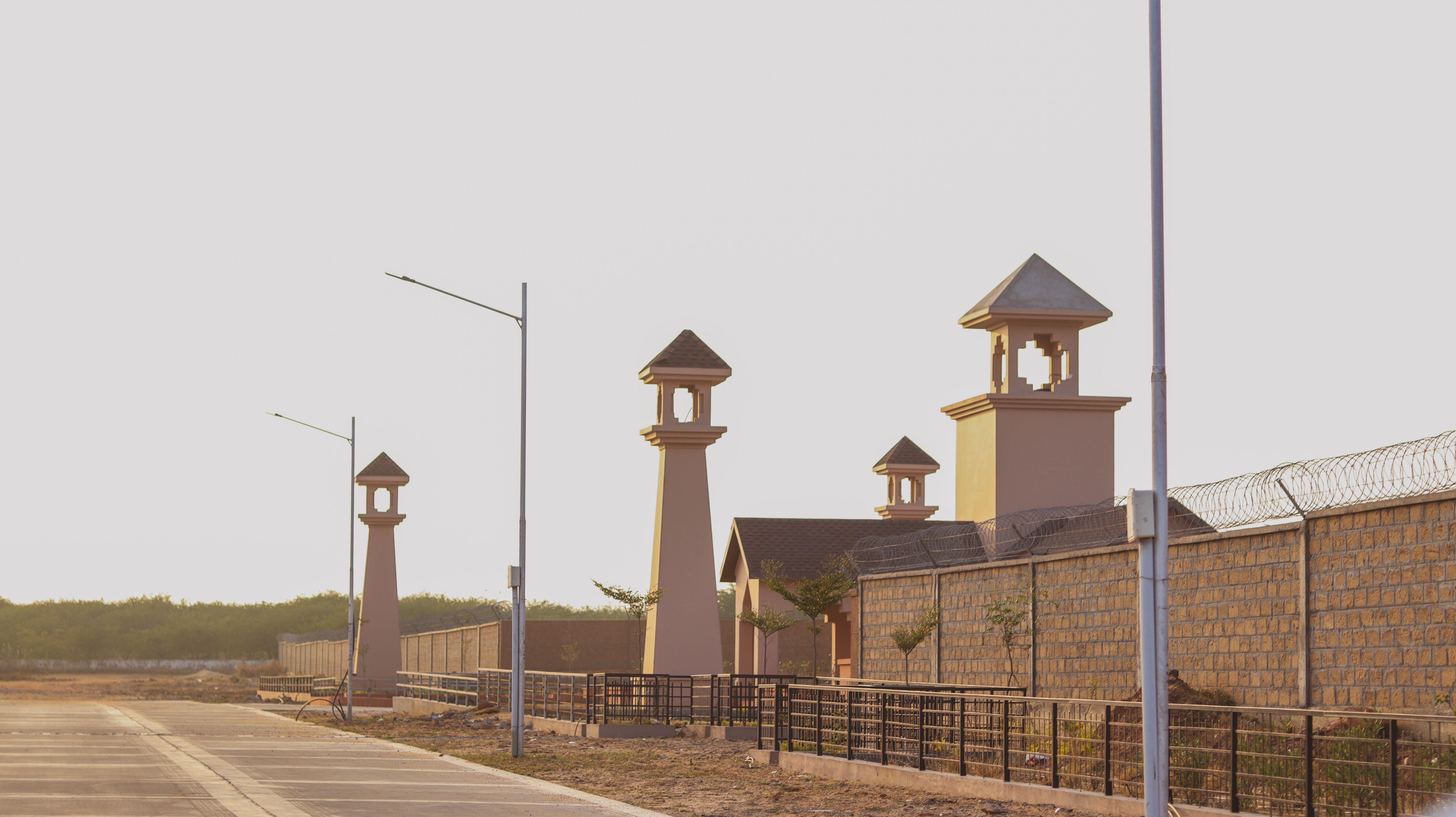 An industrial street scene featuring distinctive tower architecture at sunset.