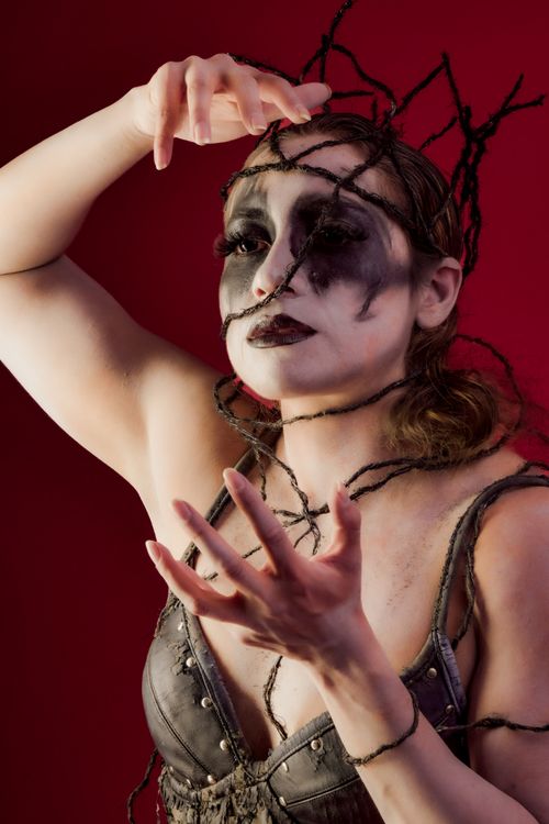 Free Intriguing artistic portrait with dramatic makeup and unique costume elements expressing fantasy themes. Stock Photo