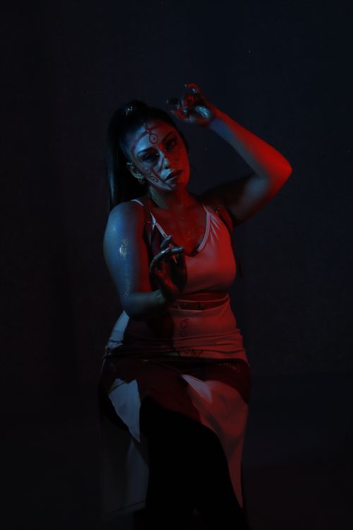 Free Woman with body art in dramatic red and blue lighting Stock Photo