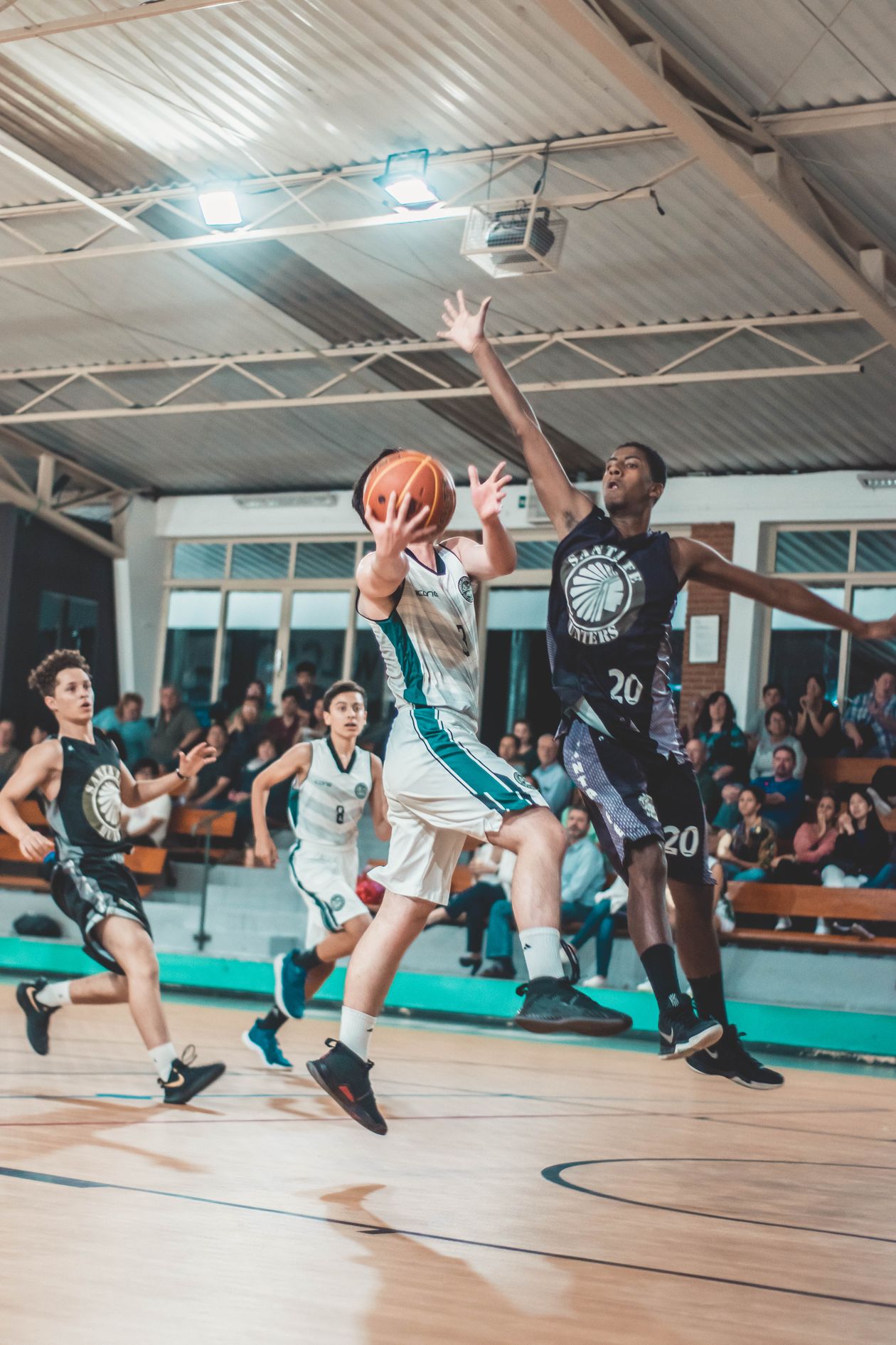 Basketball players competing in intense indoor game