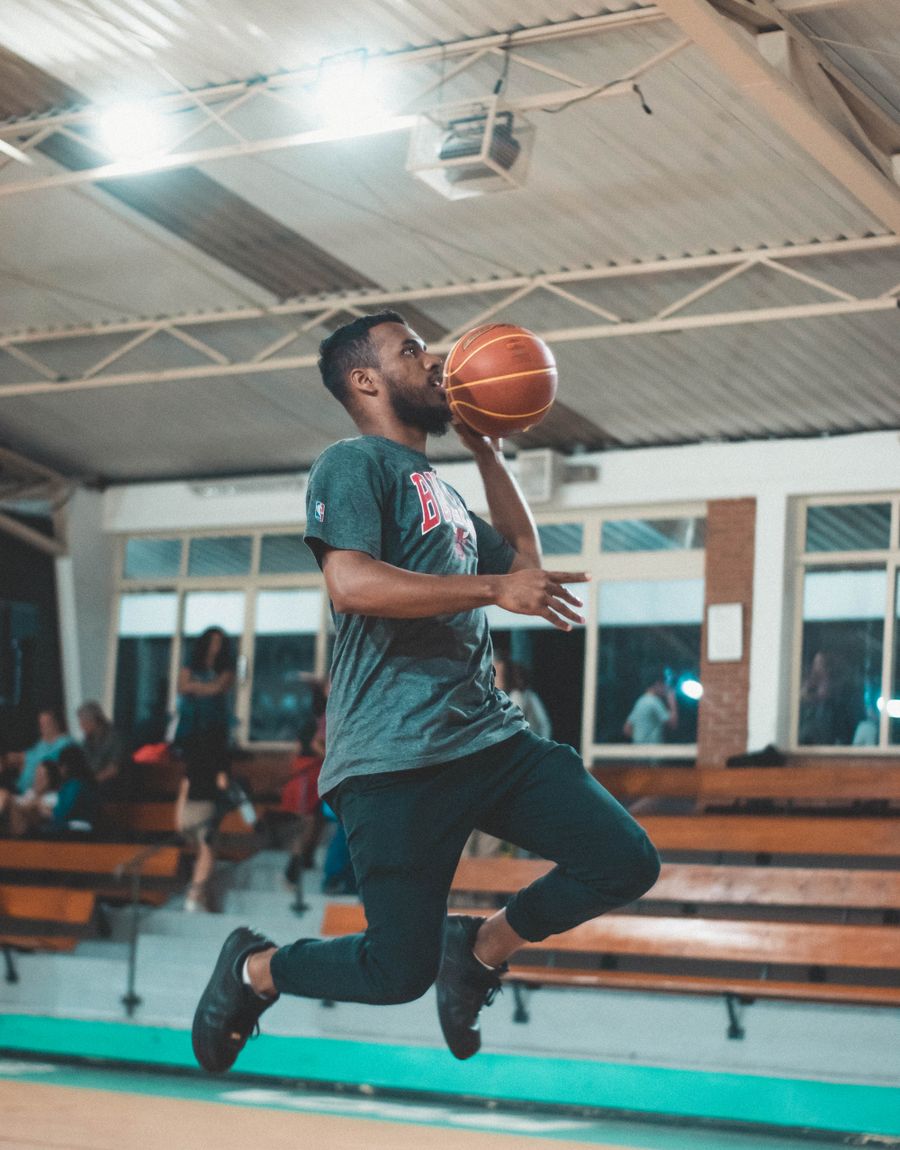 Basketball player rising for a jump shot in a Meridian uniform
