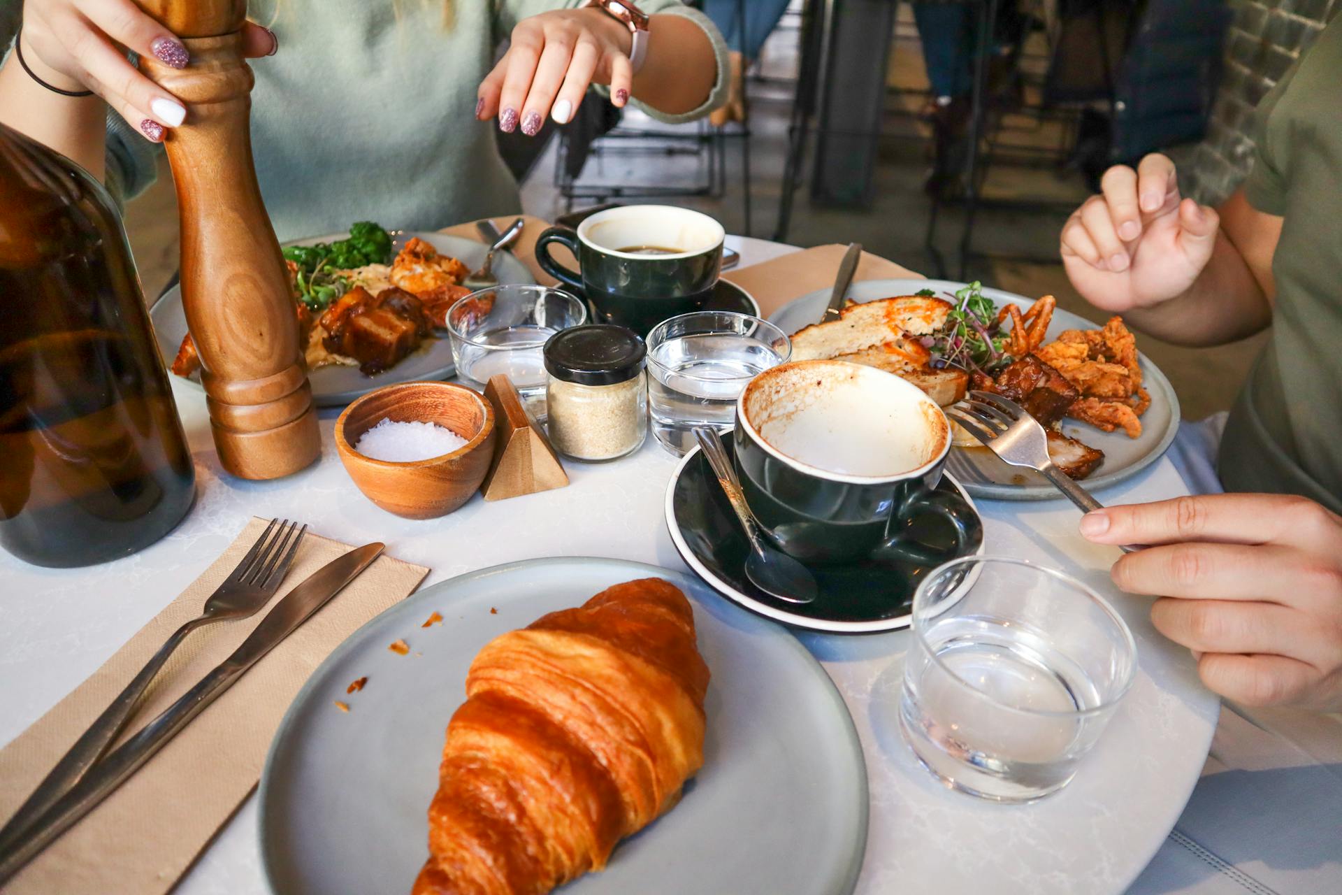 Casual brunch scene with croissants and coffee, ideal for food and lifestyle themes.