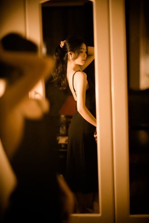 Free Elegant Asian woman in a reflective pose indoors, captured creatively. Stock Photo