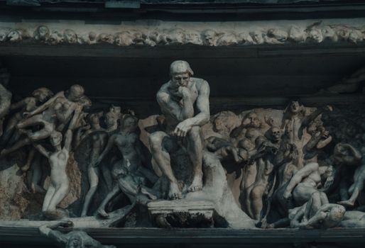 Detailed stone sculpture showing mythical and classical figures in intricate relief.