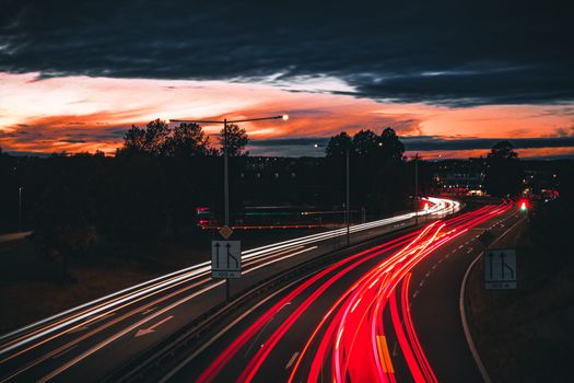 Stunning long exposure photo capturing light trails on a highway at sunset in Jönköping, Sweden.