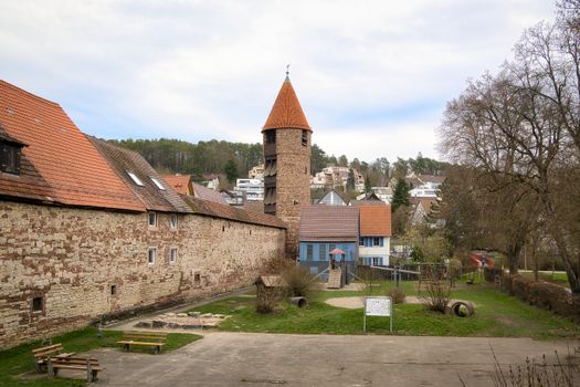 Scenic view of historic tower in Weil der Stadt surrounded by spring greenery and traditional architecture.