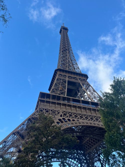 Free Majestic view of the Eiffel Tower against a clear blue sky in Paris, France. Stock Photo
