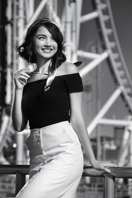 Black and White Photograph of Woman in Off-shoulder top and Skirt Smiling