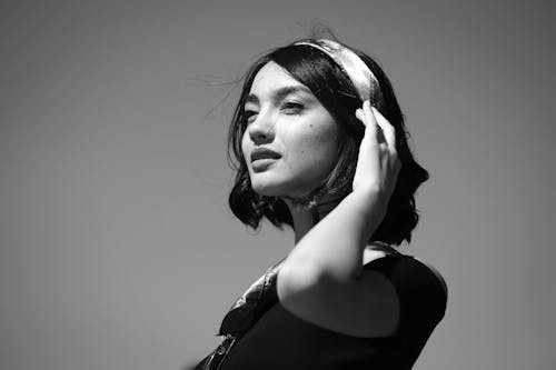 Monochrome Photo of Woman Touching Her Hair