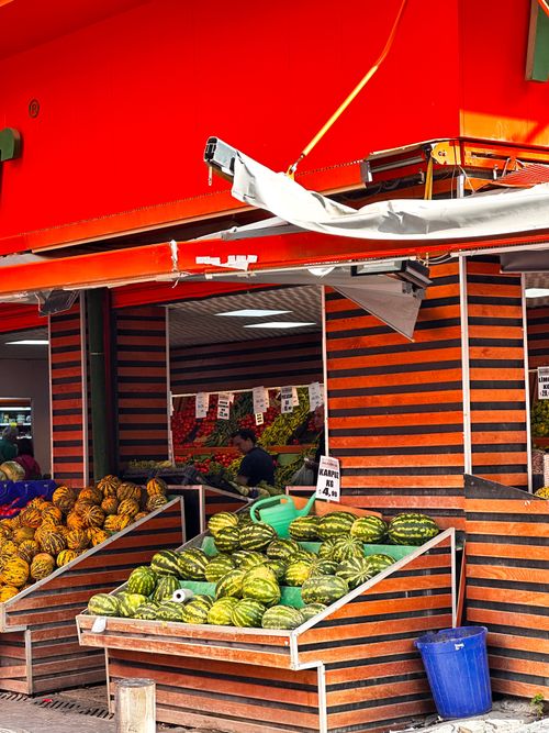 Free Vibrant outdoor market stall in İzmir offers a variety of fresh watermelons and melons under red awnings. Stock Photo