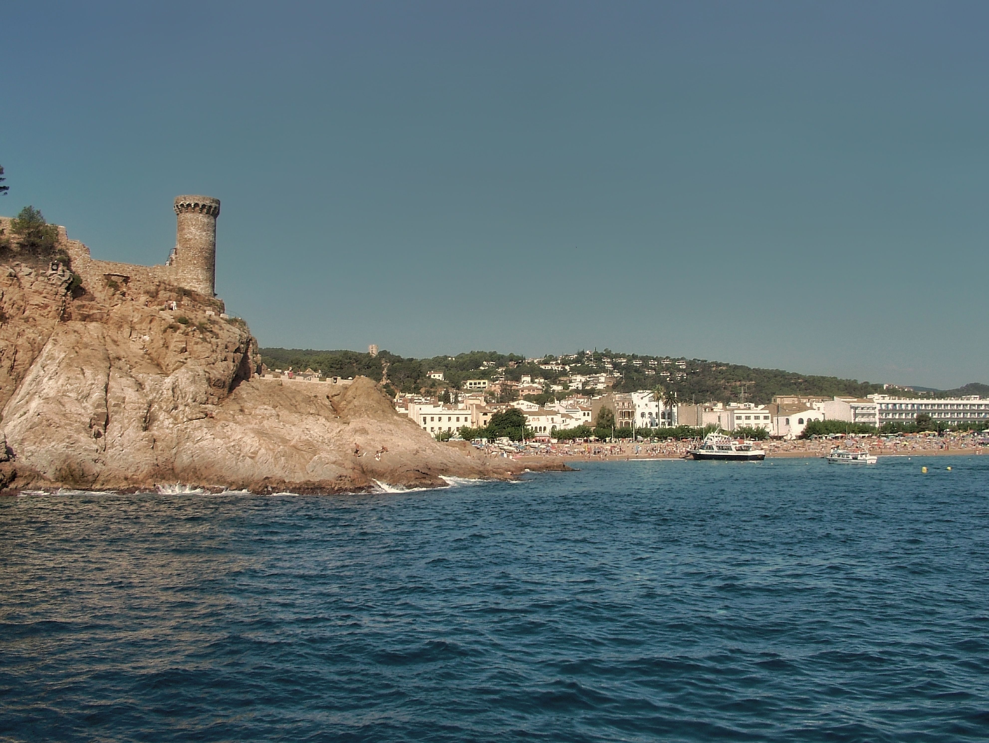 Explore the stunning coastline of Tossa de Mar, Spain with its historical castle and azure waters.