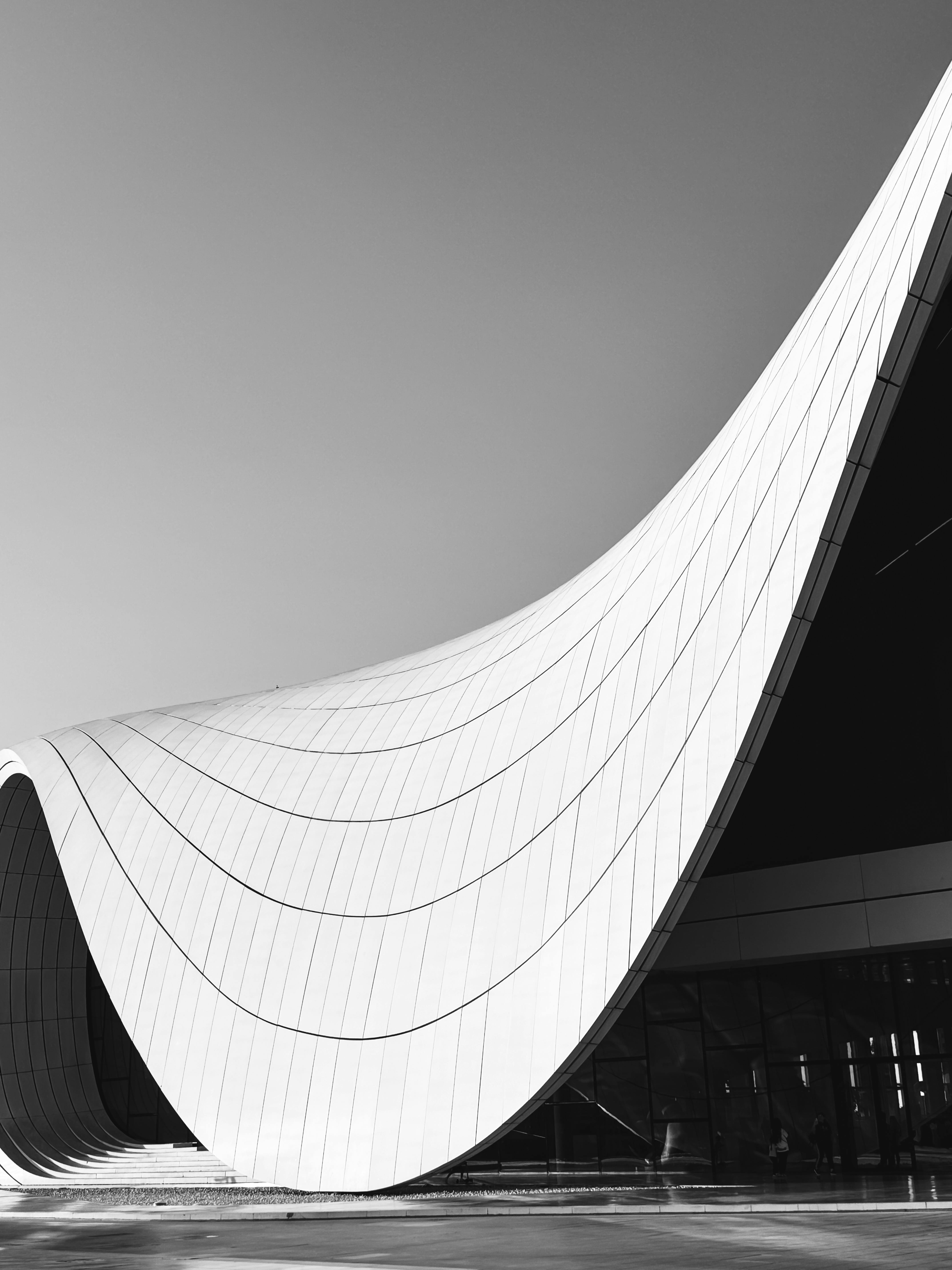 Black and white photo showcasing Heydar Aliyev Center's flowing architecture in Baku, Azerbaijan.