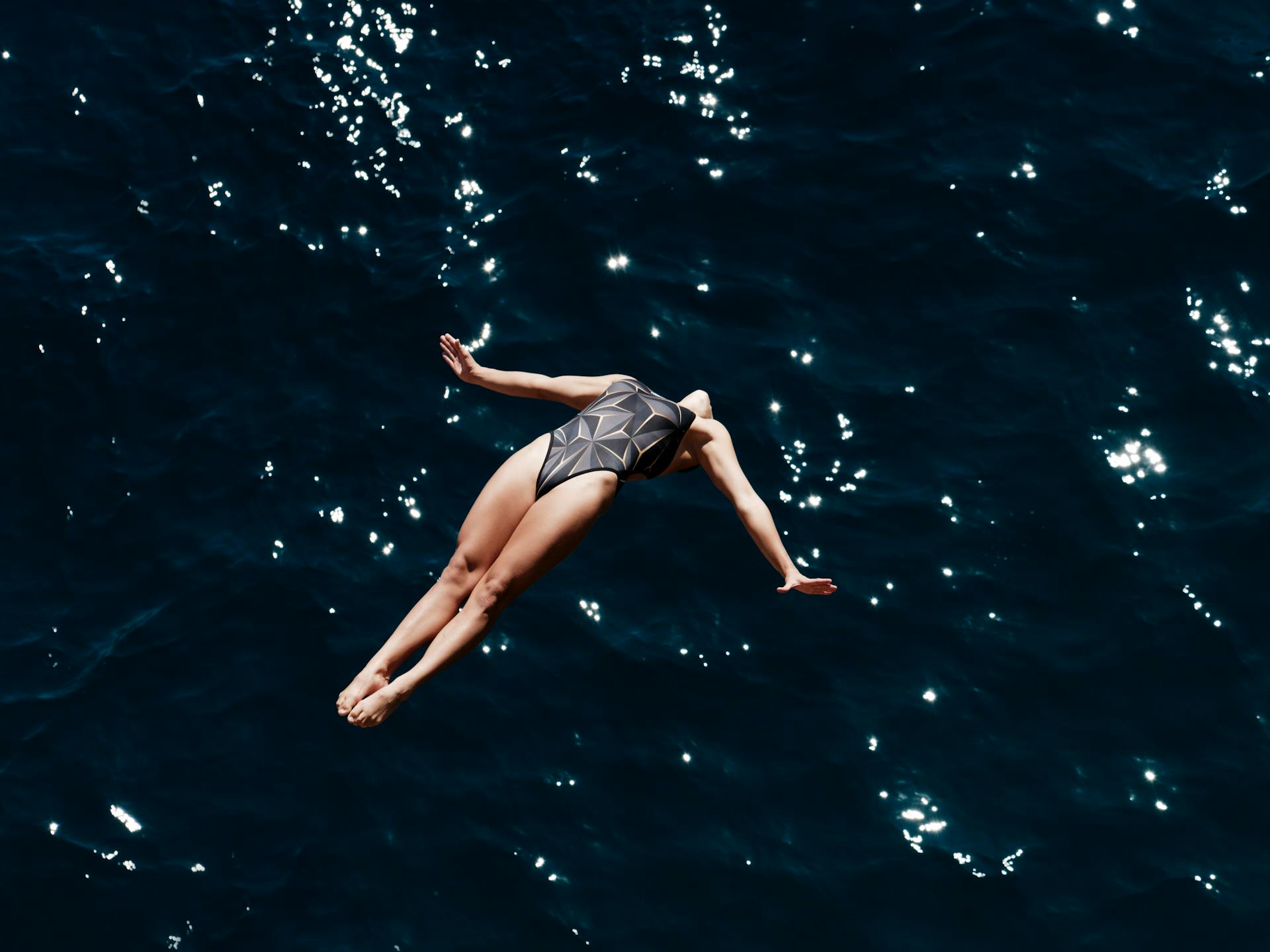 Fearless Woman Diving into Ocean Waters