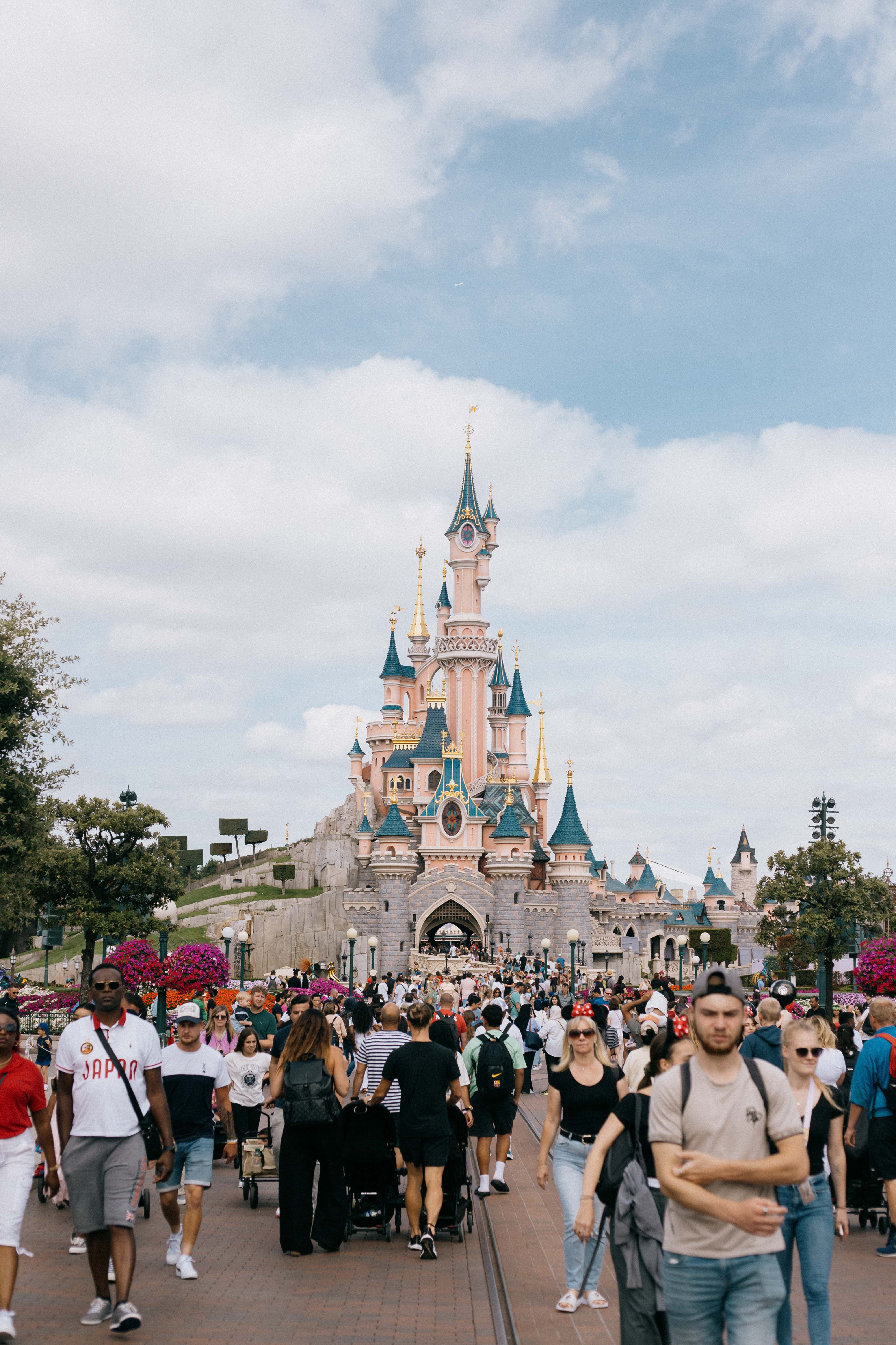 Vibrant Crowd at Disneyland Paris with Castle View · Free Stock Photo