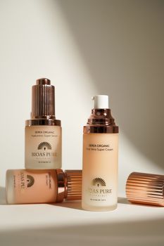 Elegant cosmetic bottles artfully arranged with minimalist design.