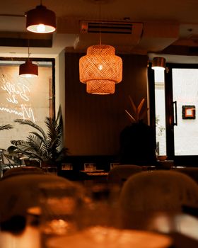 Warmly lit Madrid cafe interior with hanging lamps and rustic decor, creating a cozy atmosphere.