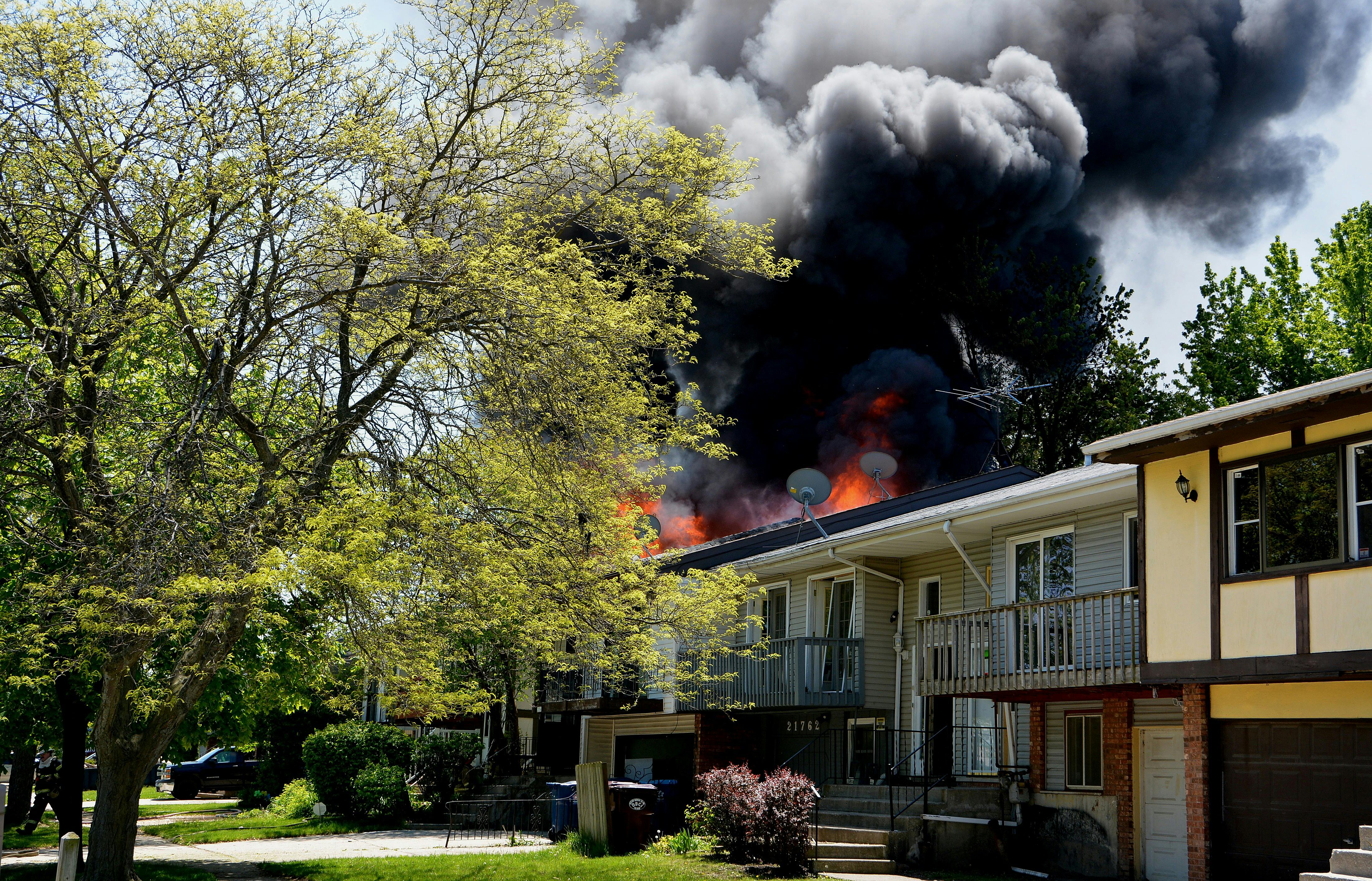 House Fire with Smoke in Suburban Neighborhood · Free Stock Photo