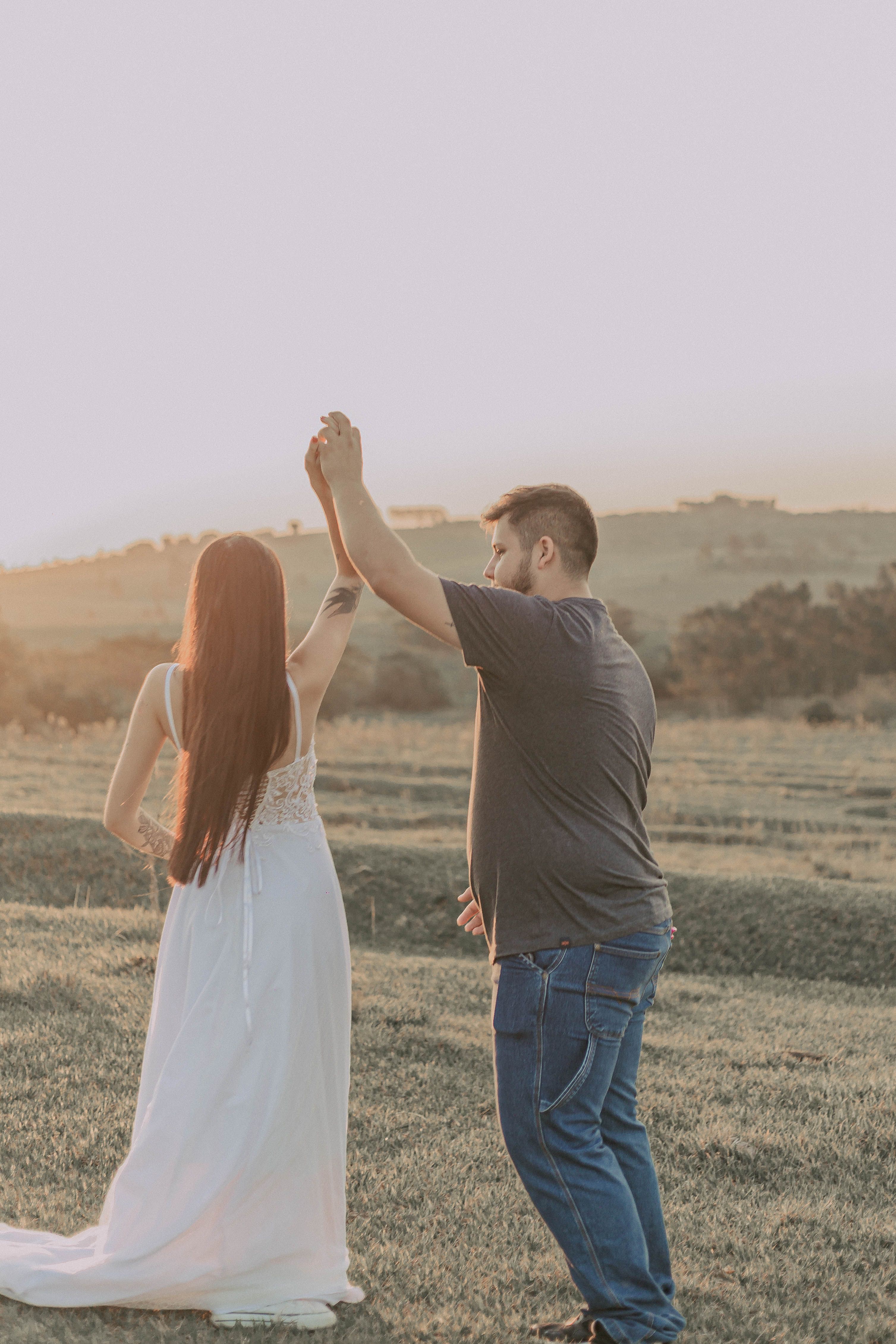 Romantic Couple Dancing Outdoors at Sunset · Free Stock Photo