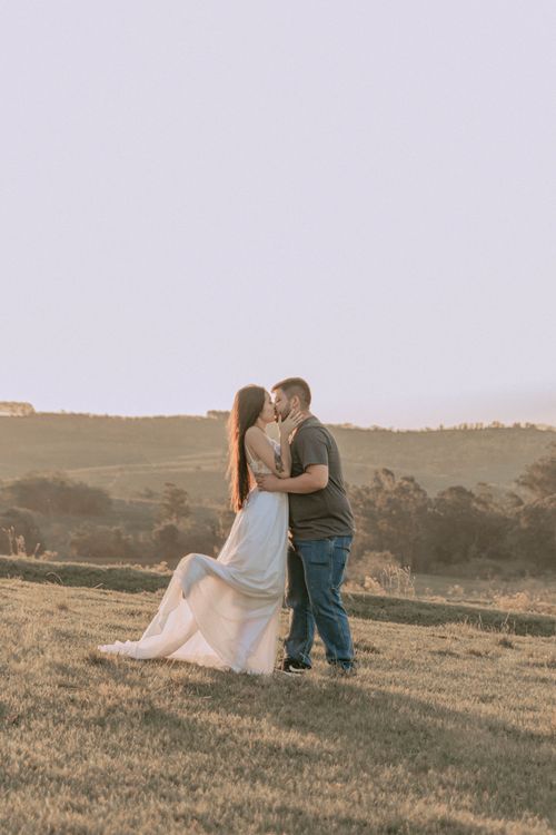 Free A couple shares a tender moment outdoors at sunset, symbolizing love and connection. Stock Photo