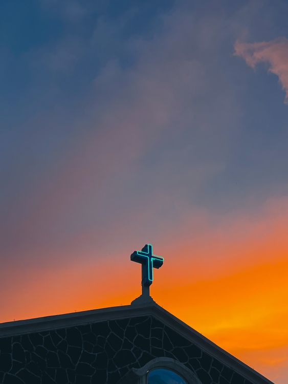 Silhouette of Church Cross Against Vibrant Sunset · Free Stock Photo