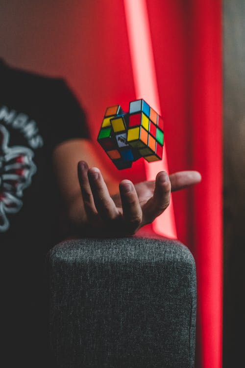 Free Elevating 3x3 Rubik's Cube on Person's Palm Stock Photo