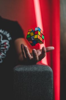 hand balancing a colorful 3x3 puzzle cube