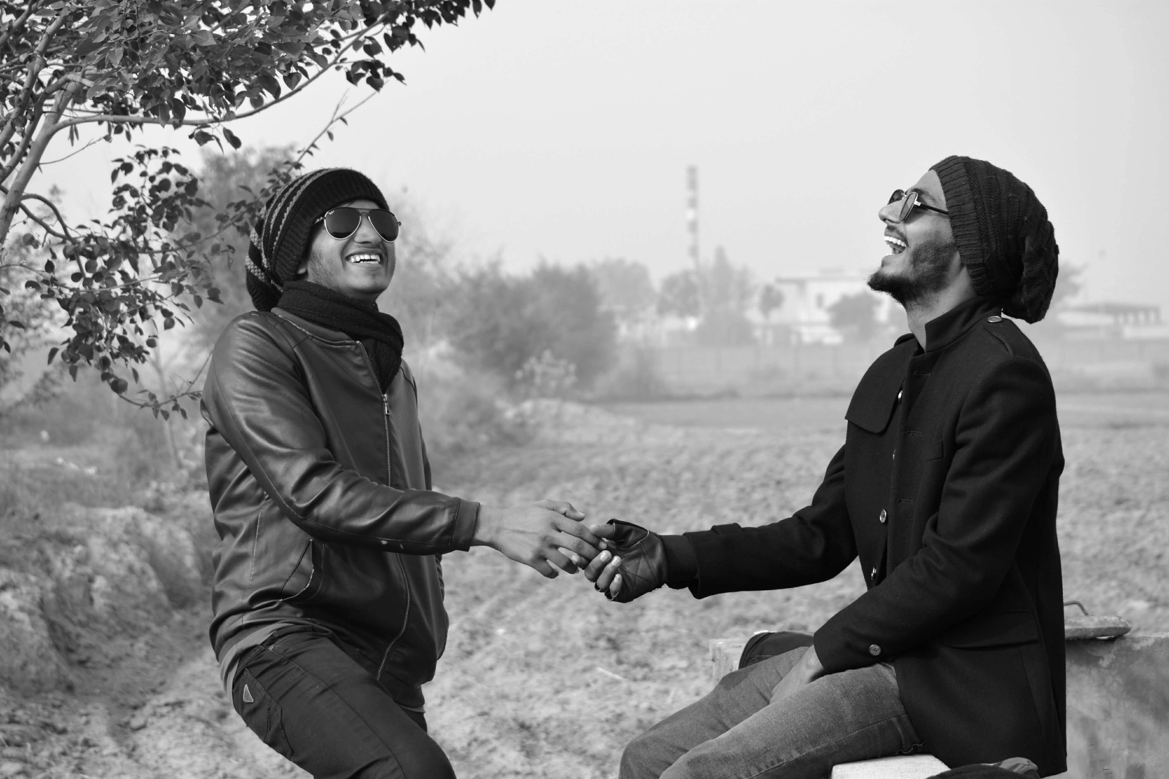 joyful friends laughing in black and white outdoors