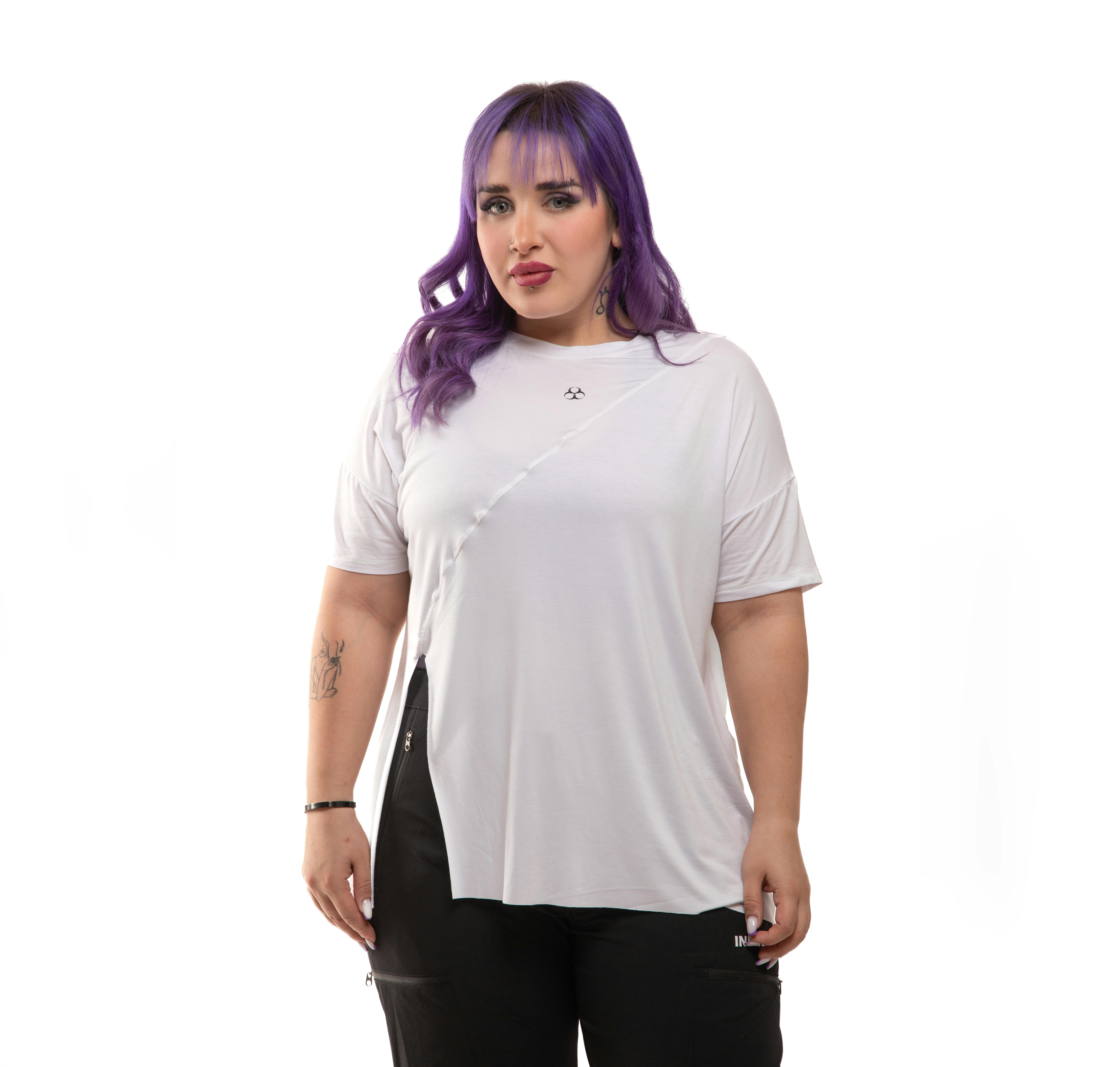 Model showcasing trendy sportswear with a white top and black leggings in a studio setting.