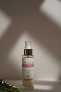 Organic rosemary hair spray bottle captured in soft, minimalist lighting.