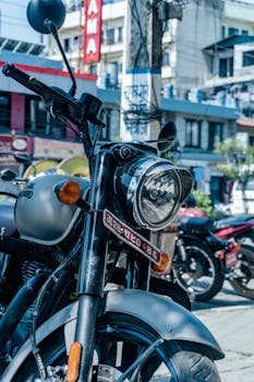 Close-up of a vintage Royal Enfield motorcycle parked on a city street.