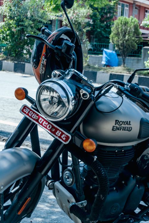 Free Close-up of a Royal Enfield motorcycle with helmet parked on a sunny day. Stock Photo