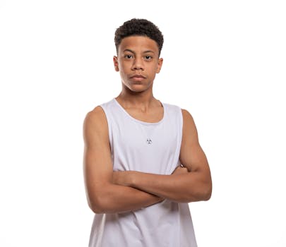 Portrait of a young man wearing sportswear, standing confidently with arms crossed.