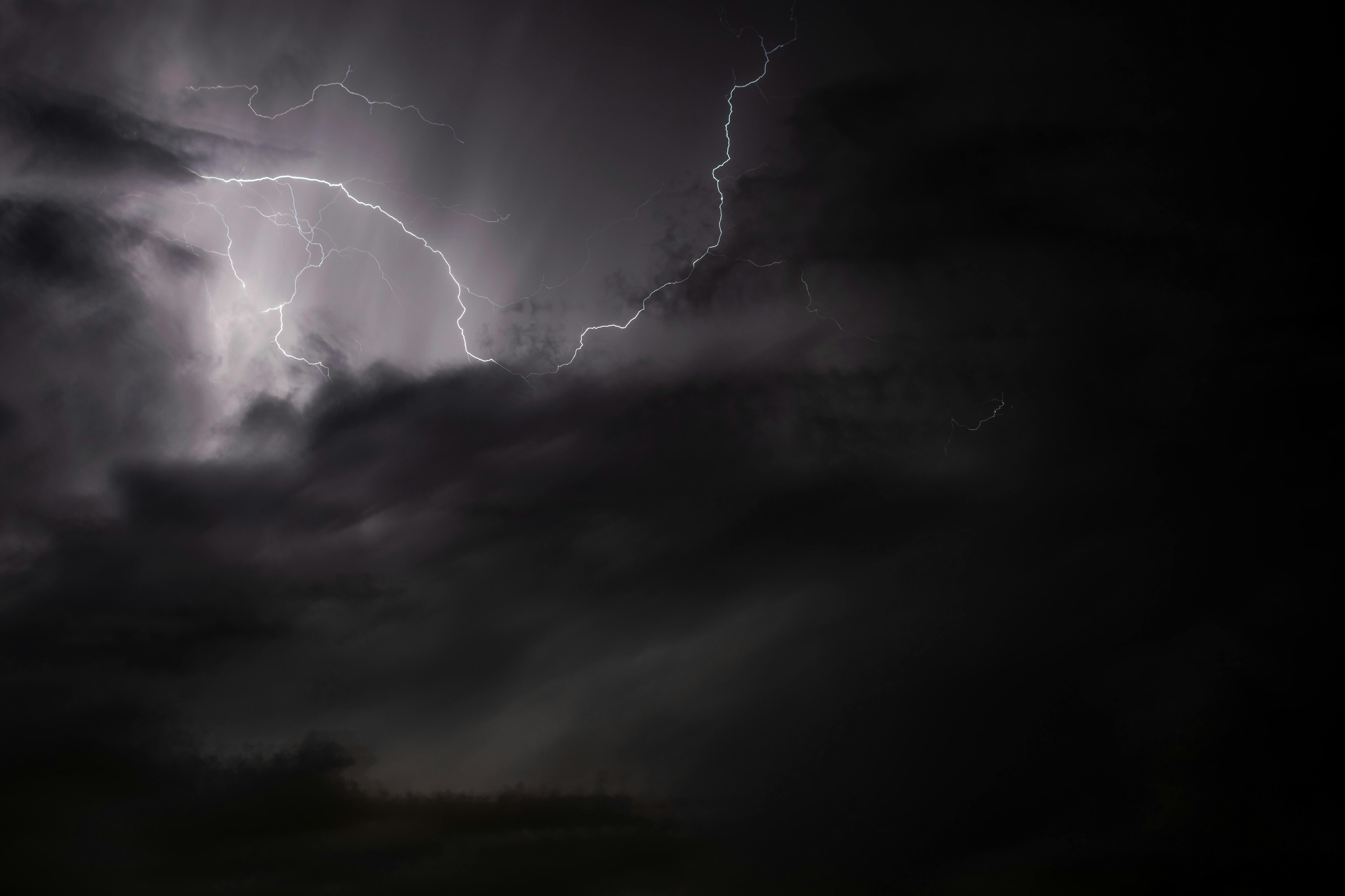 A striking image of a lightning bolt illuminating a stormy night sky, capturing the essence of nature's power.