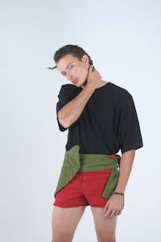 Dynamic fashion portrait featuring a model in bold red shorts and a black top, showcasing unique style.