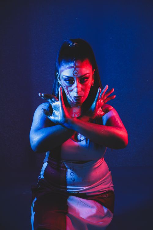 Free Artistic portrait of a woman with face paint and dramatic lighting creating a mysterious mood. Stock Photo