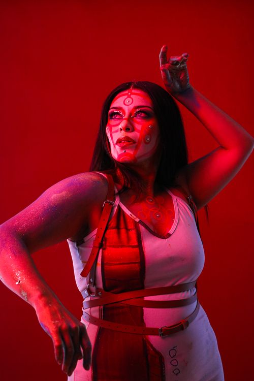 Free Creative portrait of a woman with artistic makeup under red lighting. Stock Photo