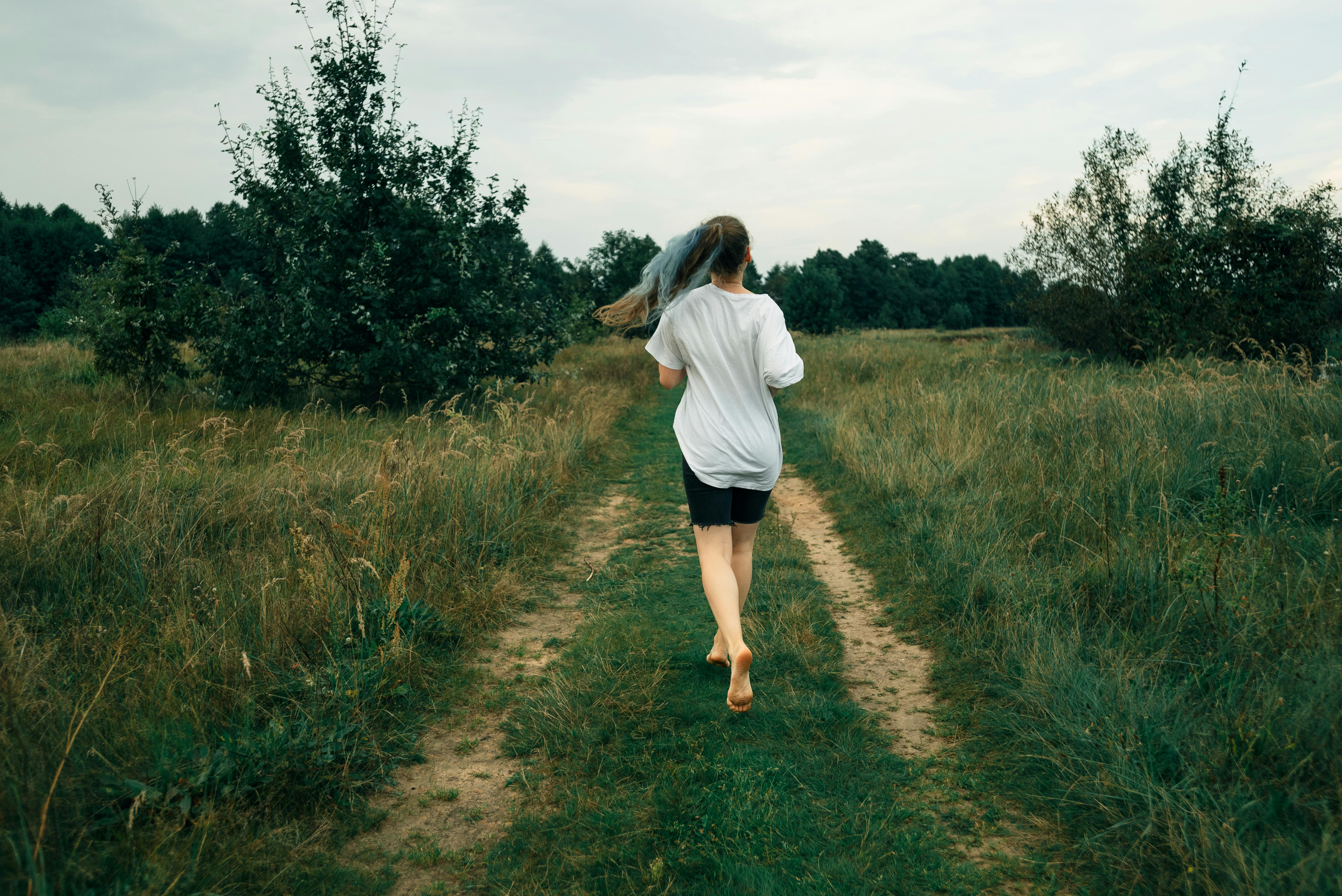 runner on serene path, early morning mist, peaceful expression