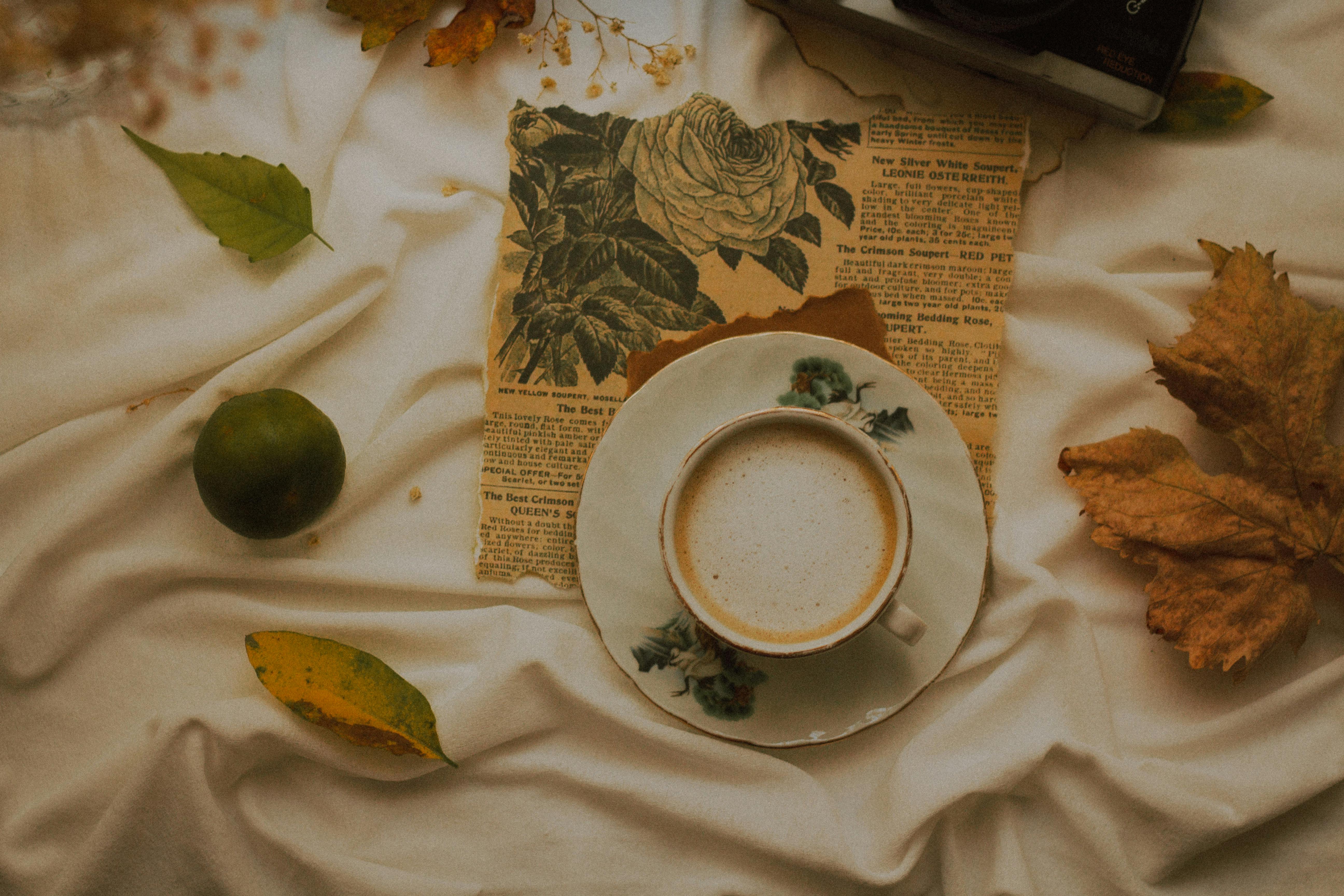 Warm autumn flat lay with a cup of coffee, leaves, and vintage vibe, perfect for seasonal themes.