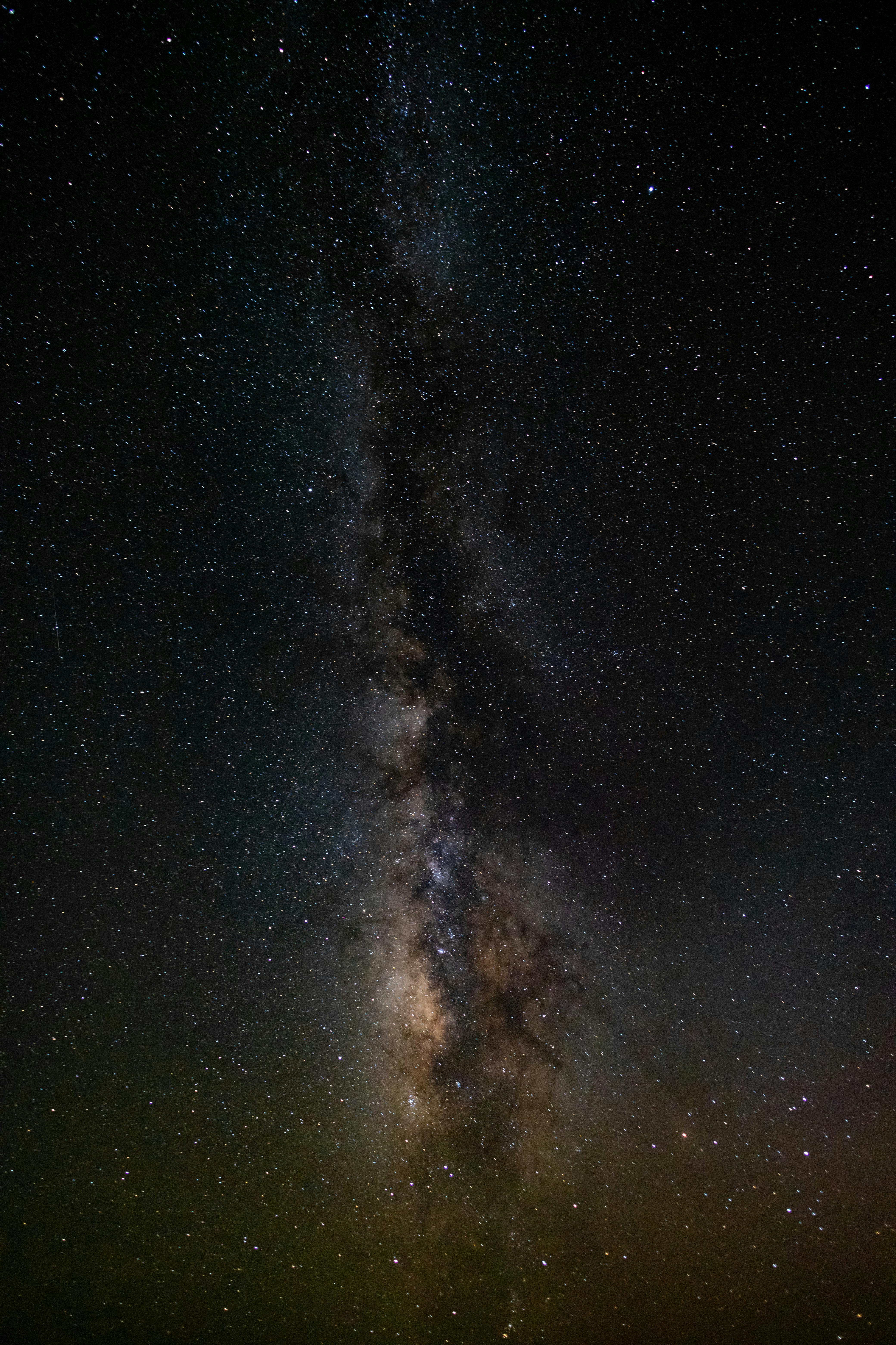 A mesmerizing view of the Milky Way stretching across a star-filled night sky.
