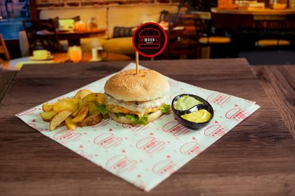 Burger on a warm wooden table — photo by Zoom Digital Studio on Pexels