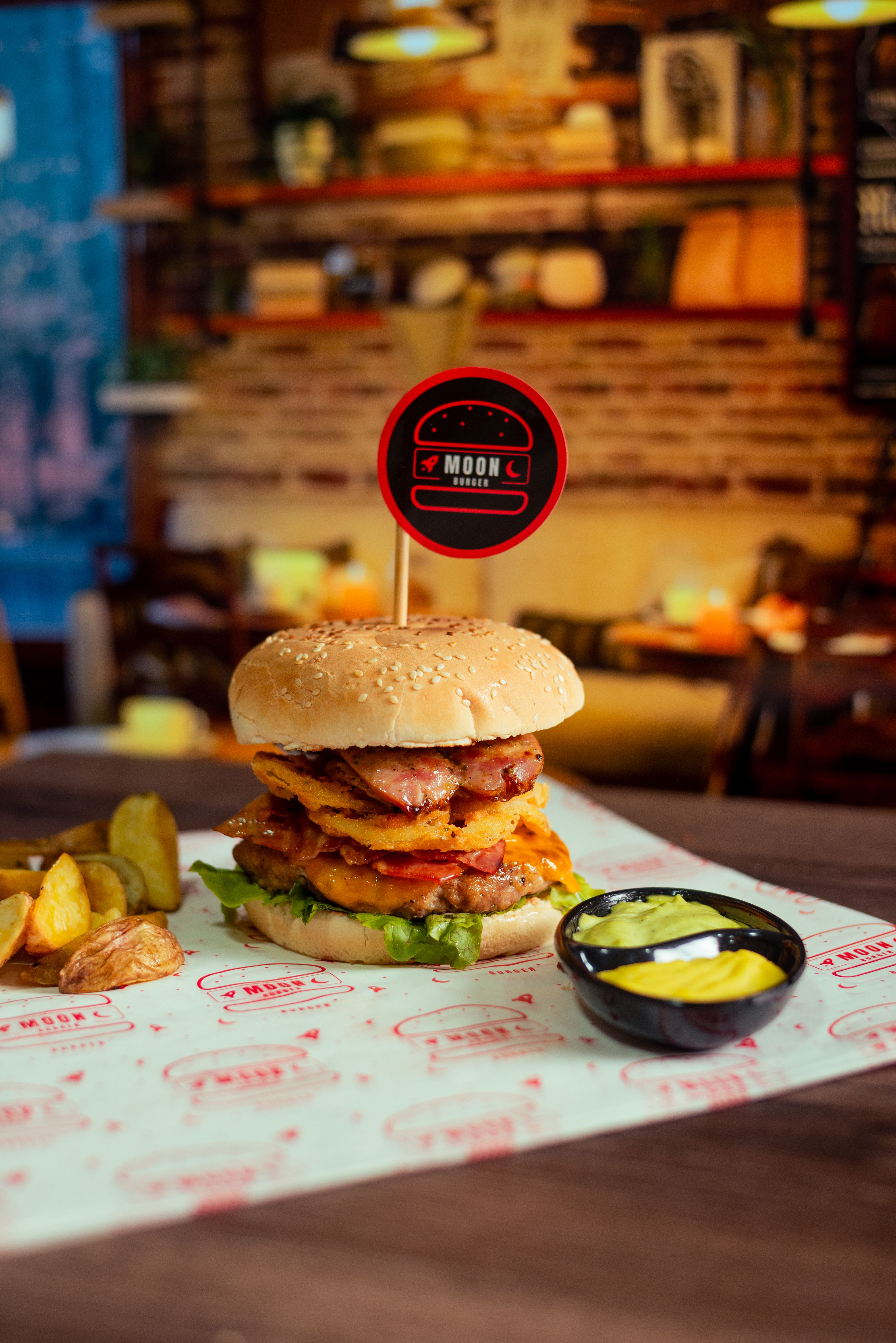 Delicious gourmet burger with crispy fries served in a cozy restaurant setting, perfect for food lovers.