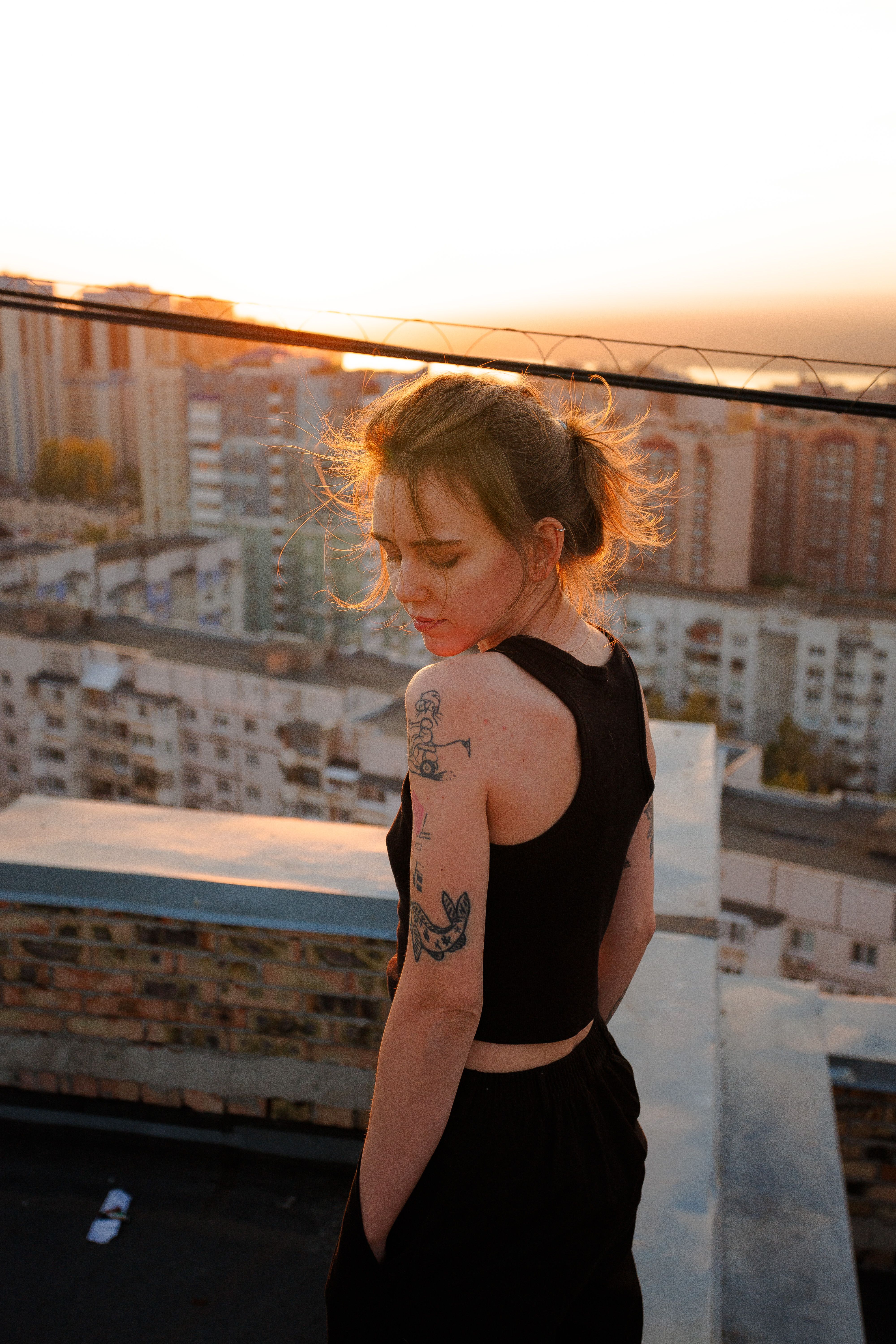 Sunset Portrait on Rooftop with Urban Skyline · Free Stock Photo