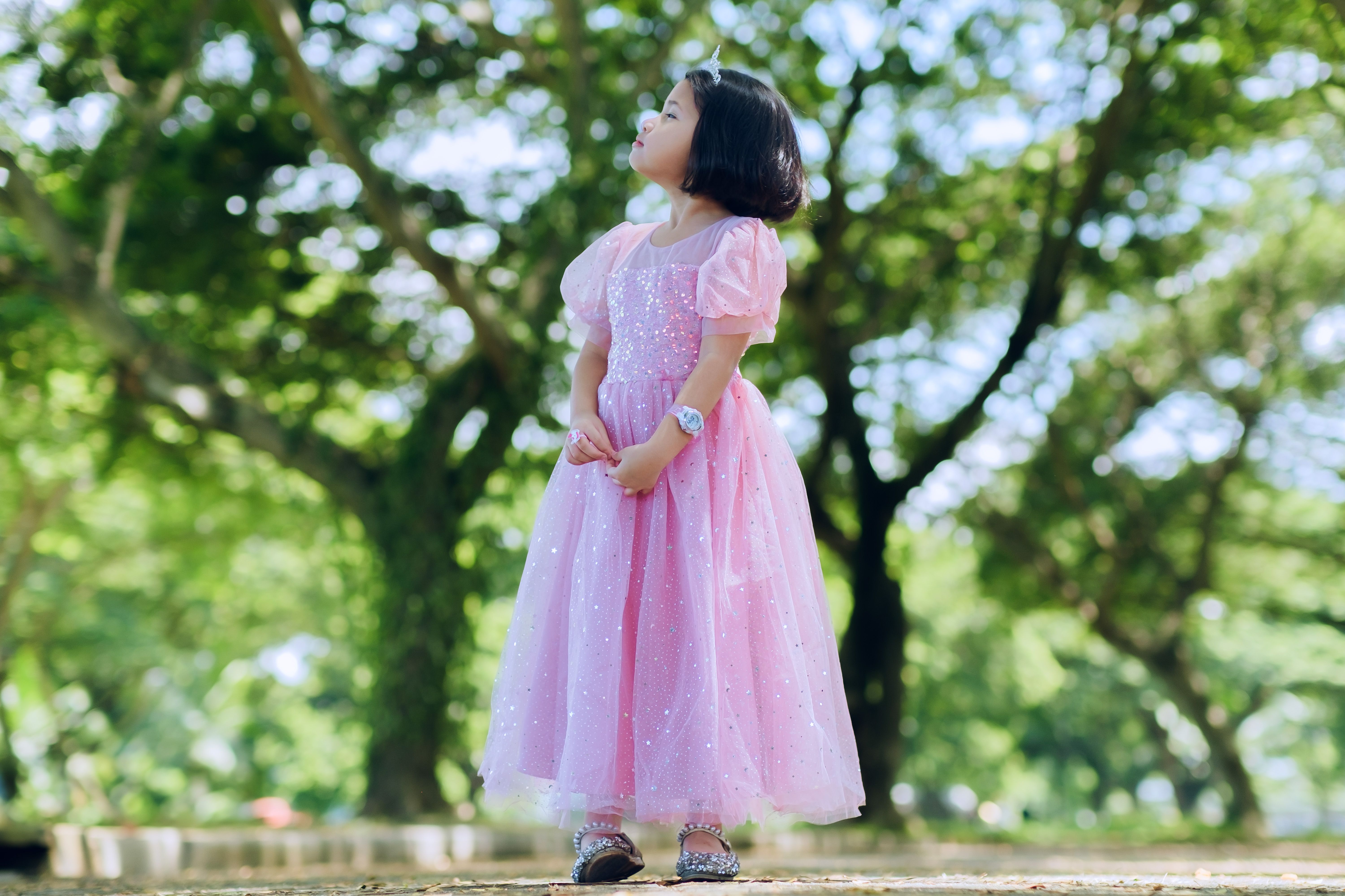 Little Girl in Pink Dress in Sunlit Forest · Free Stock Photo