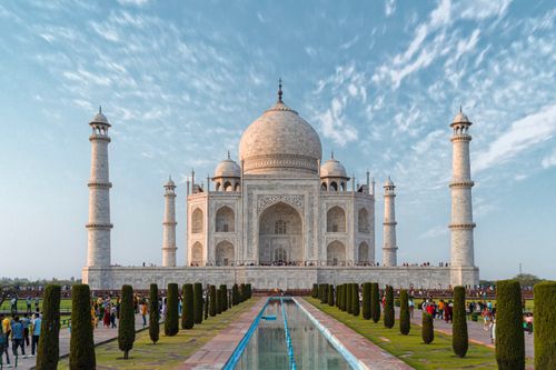 Free Front view of the Taj Mahal, showcasing its iconic architecture against a blue sky. Stock Photo