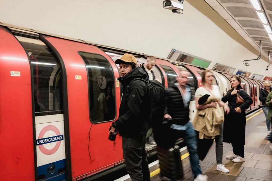 Commuters crowded together on a busy underground train platform
