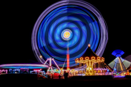 Free Colorful long exposure shot of Ferris wheel and rides at night in Jönköping, Sweden. Stock Photo